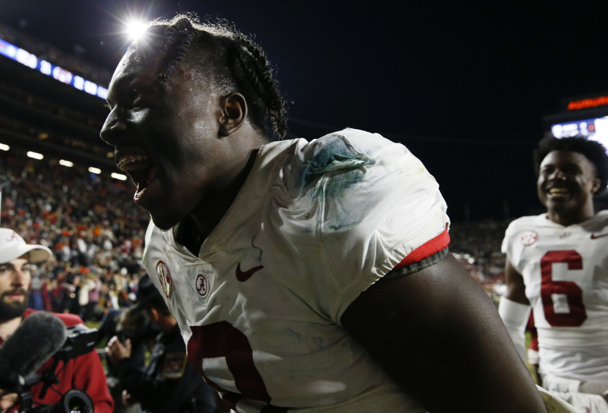 Alabama Crimson Tide linebacker Christian Harris (8) celebrates as he leaves the field after defeating the Auburn Tigers at Jordan-Hare Stadium. Alabama defeated Auburn in four overtimes